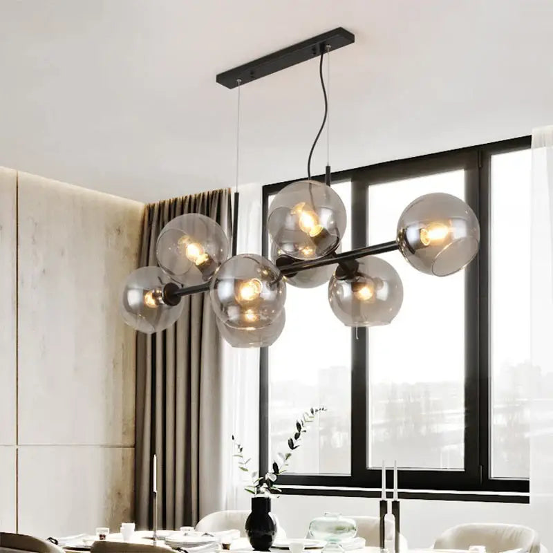 Modern black metal chandelier with smoked glass globe bulbs designed as gray glass pendant lights for kitchen dining room