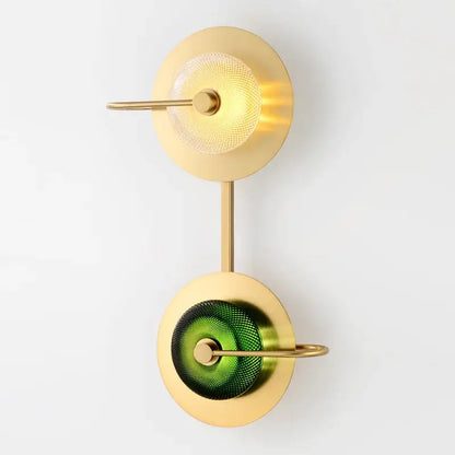 Modern brass and green glass metal wall art lamp with two circular shades mounted on slender brass stems for living room wall art