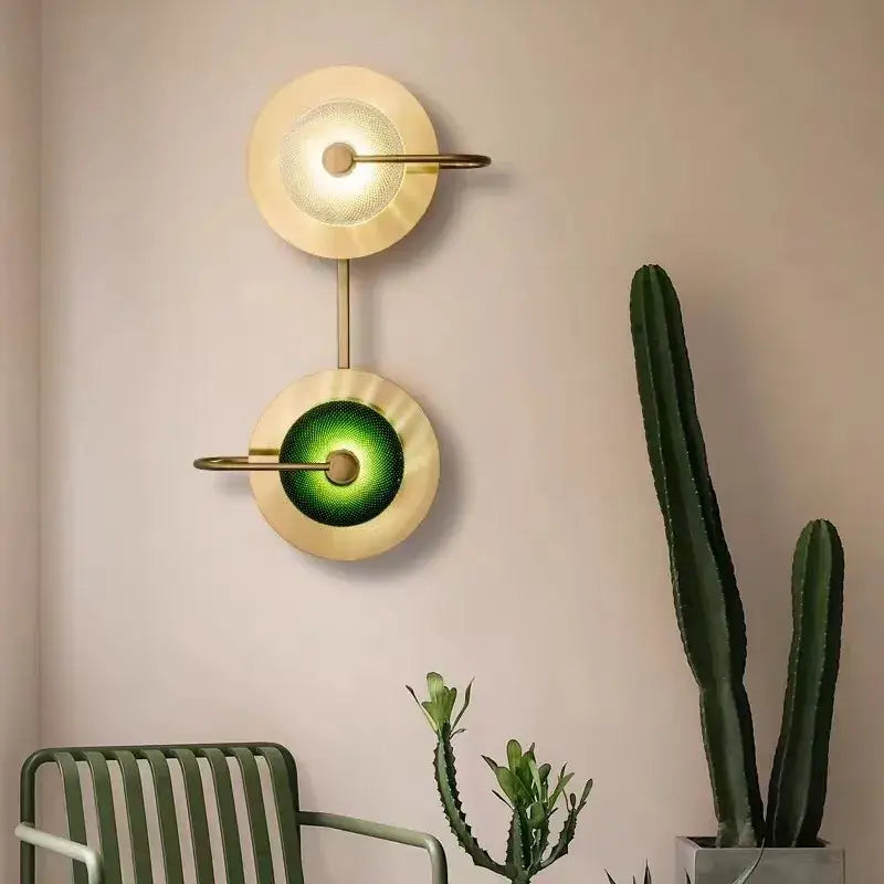Modern brass and green glass metal wall art lamp with gold-toned sconce and dual circular shades for living room