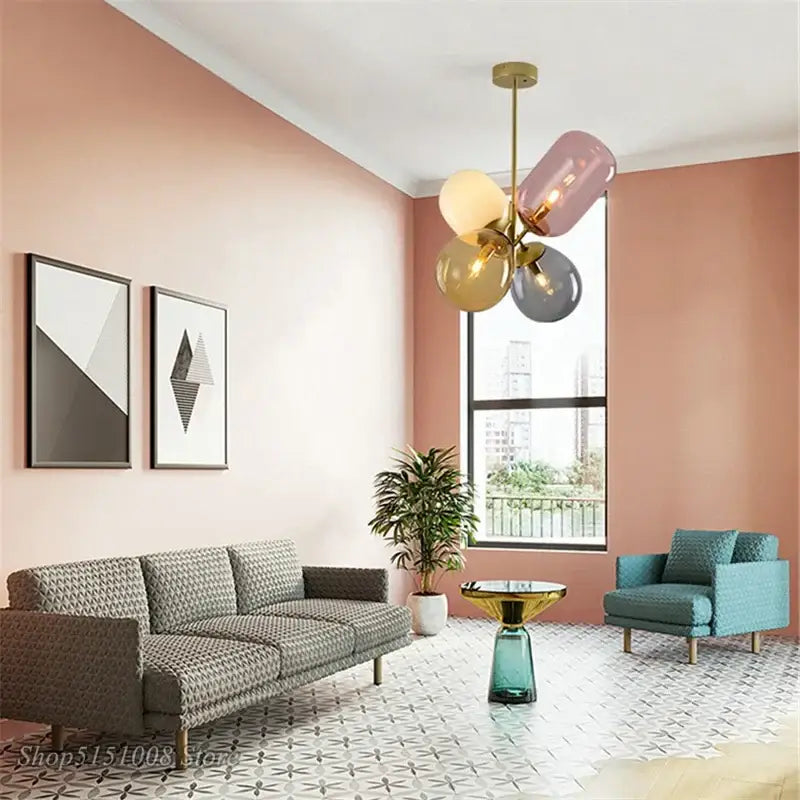 Modern brass and multi color glass pendant light with four colorful translucent globes in pink gold and gray for dining room