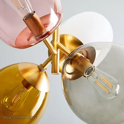 Modern brass pendant light with multi color pink amber and clear glass pendant shades for dining room use