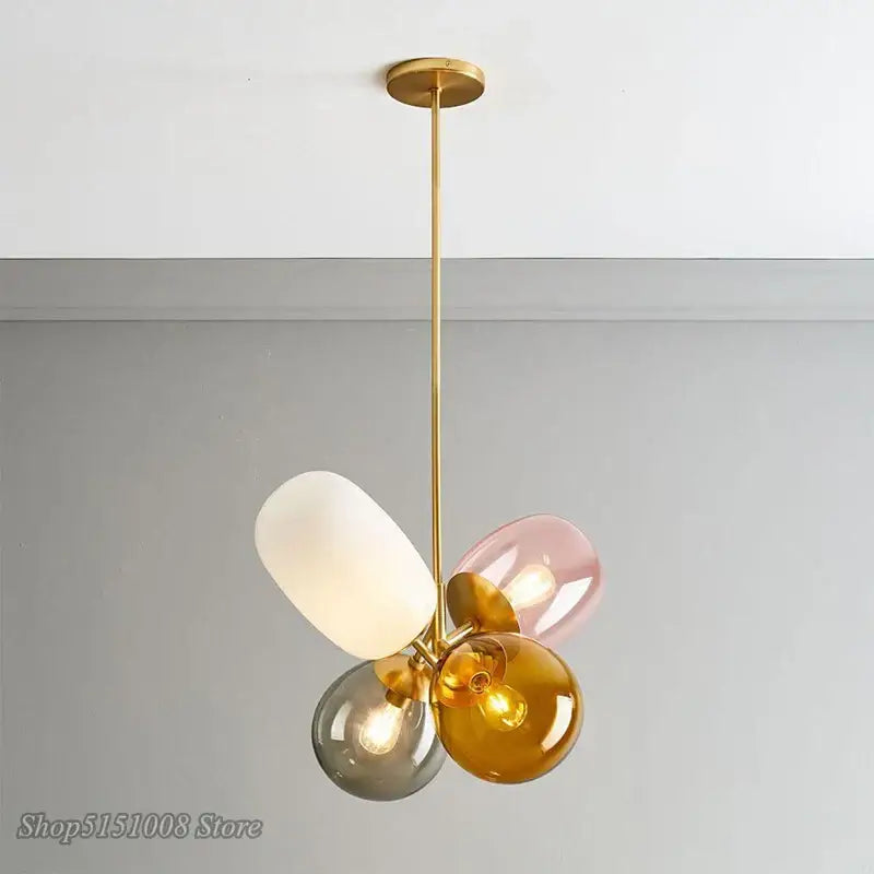 Modern brass and multi color glass pendant light with four glass pendant shades in white pink amber and gray for dining room