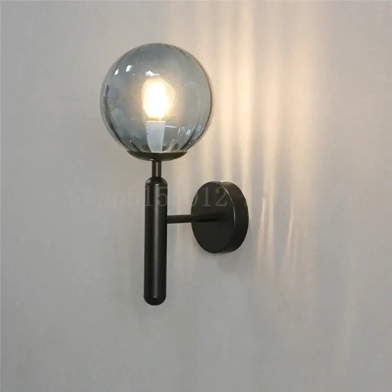 Black metal wall lamp with frosted glass globe combining modern brass and pink glass elements for living room decorbites blue glass balls