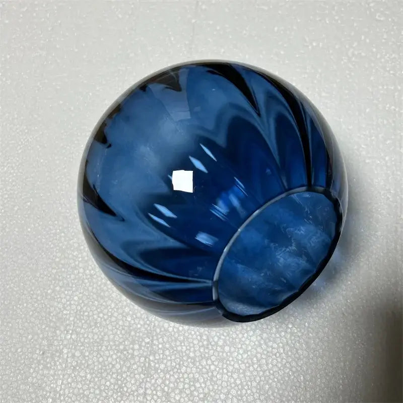 Modern brass and pink glass wall lamp with deep blue glass vase featuring swirling petal pattern for living room decorbites blue glass balls