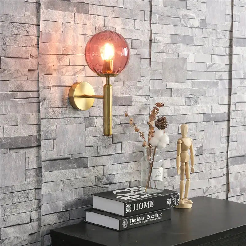 Modern brass and amber glass wall lamp with polished brass arm and circular backplate for living room decorbites blue glass