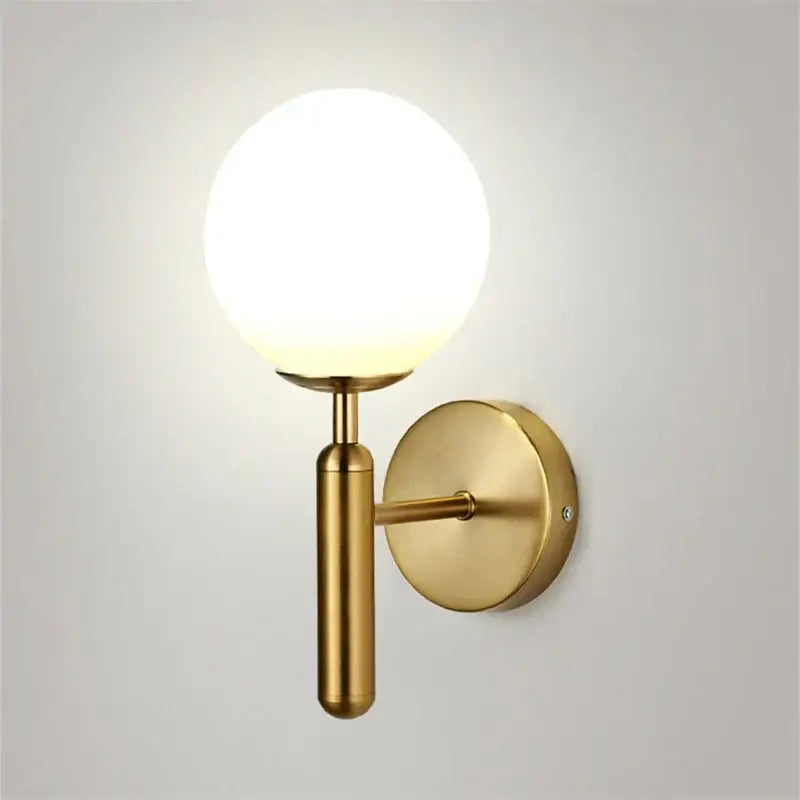 Modern brass wall sconce with gold finish and spherical frosted glass globe for bedroom decorbites blue glass style