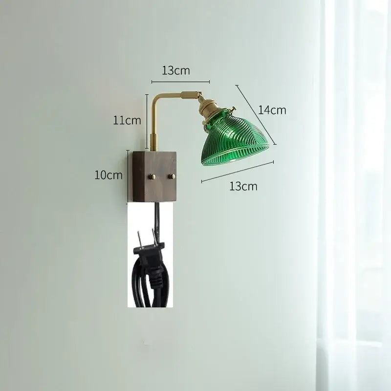 Modern brass wall lights featuring a green ribbed clear glass lampshade mounted on a brass arm and dark metal base decorbites clear glass