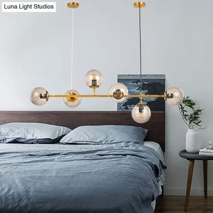 Decorbites™ modern bubble chandelier lighting with six smoke gray glass globe bulbs and gold-toned fixture bar