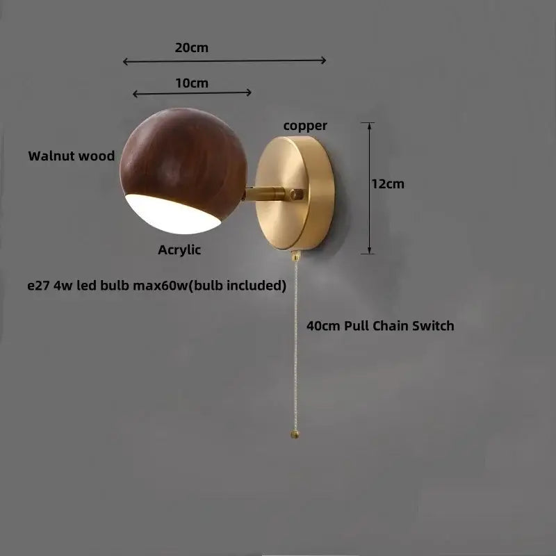 Modern brass and walnut led wall sconce with copper accents and a spherical acrylic diffuser for bedroom lighting