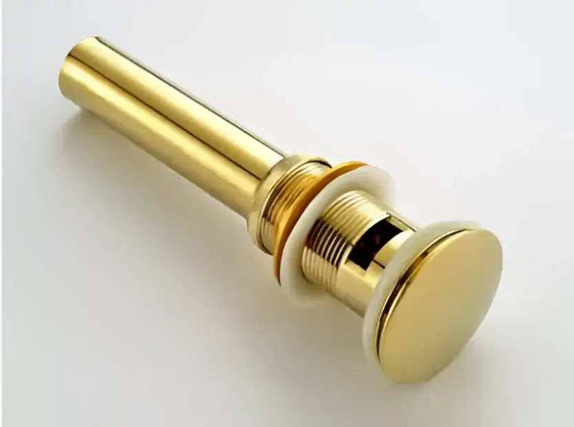 Modern brass and white ceramic basin waste drain stopper with copper finish and sleek cylindrical design with threaded base