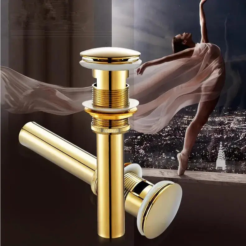 Modern brass and white ceramic basin waste drain with gold-toned cylindrical design and white ceramic stopper for bathroom sink