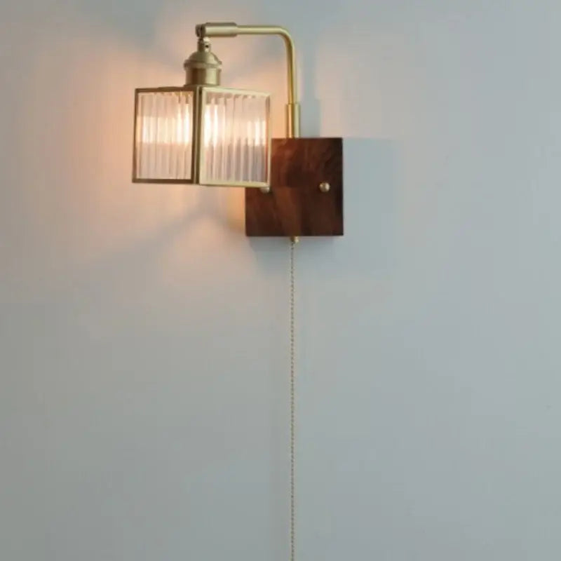 Modern brass and wood led wall light with rectangular ribbed glass shade and dark wood backplate for bedroom use