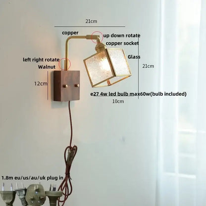 Copper-finished wall lights with a square glass shade and walnut wood base are modern led wall lights for bedrooms