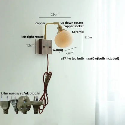 Adjustable copper wall light fixture with ceramic globe shade and walnut-finished mounting plate for bedroom use