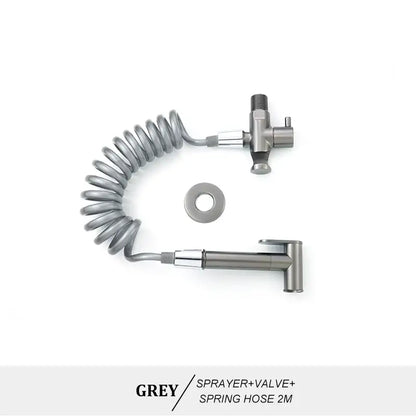 Modern brass bidet spray kit featuring a grey metallic bidet spray with coiled spring hose and valve assembly