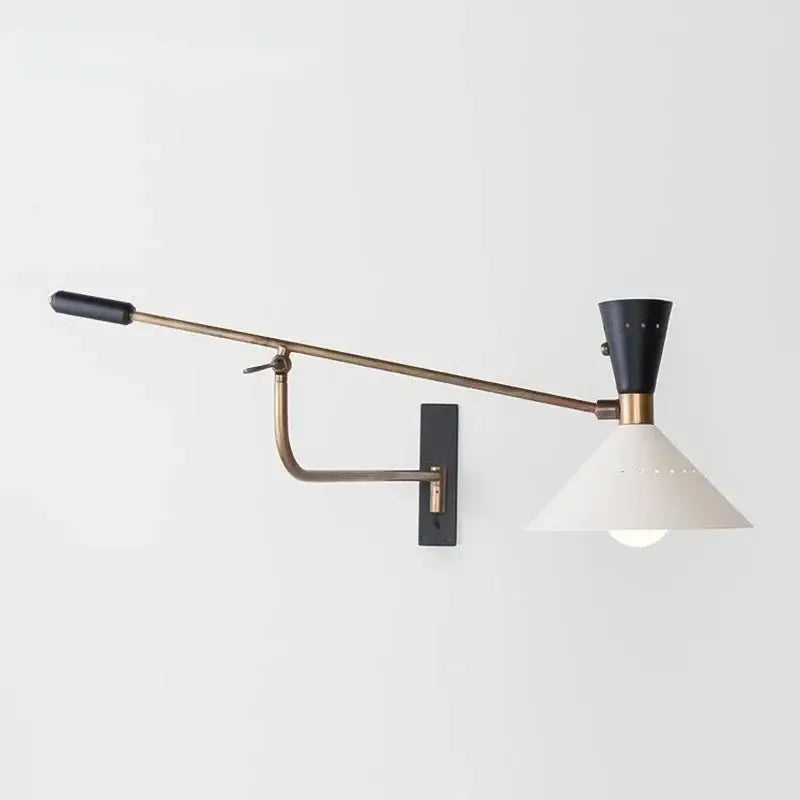 A sleek brass and black decorbites adjustable metal bedroom sconce light with a wall-mounted adjustable arm