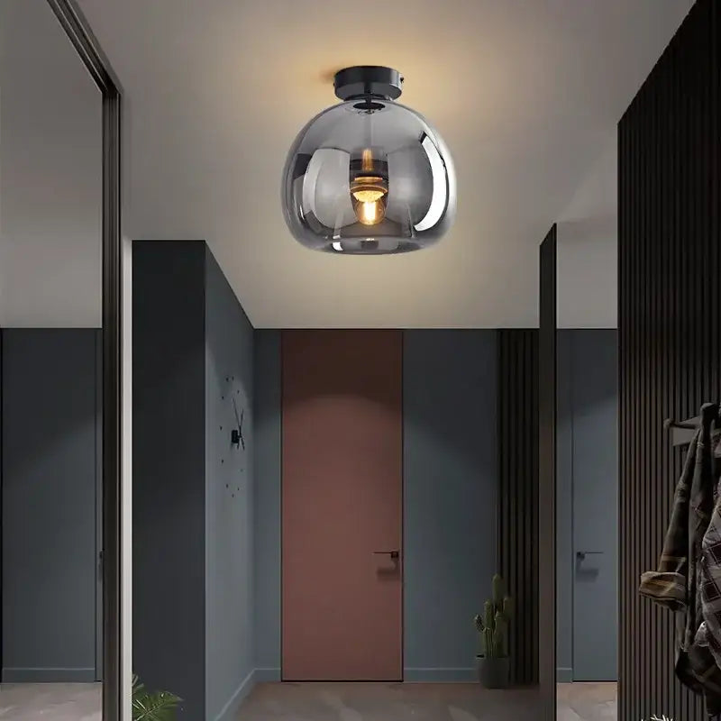 Modern brass and black glass ball led ceiling light with a sleek spherical glass pendant and exposed bulb for living room decorbites glass ball