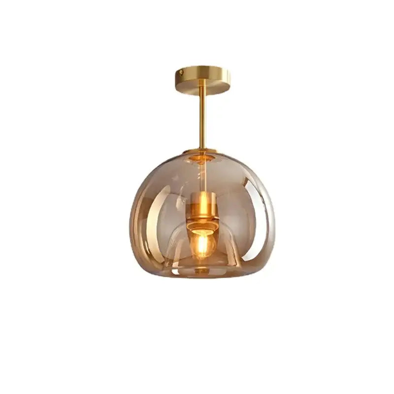 Modern brass and black glass ball led ceiling light with translucent amber glass globe for living room decorbites glass ball