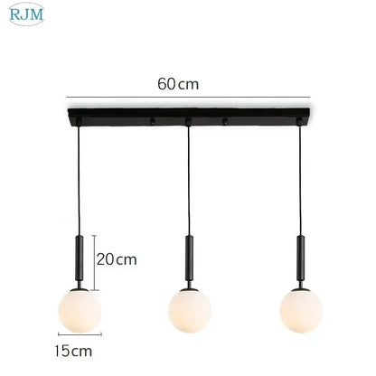 Black modern pendant light with three frosted glass ball led shades on a brass and black decorbites glass ball frame for dining room