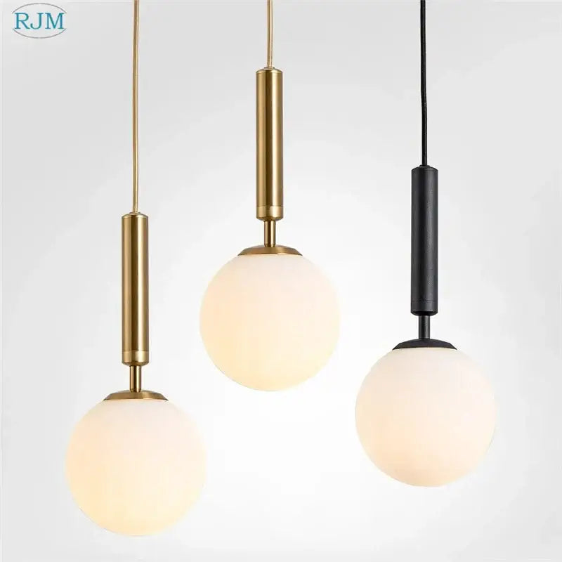 Three modern brass and black glass ball led pendant lights with frosted glass globe shades for dining room decorbites pendant light