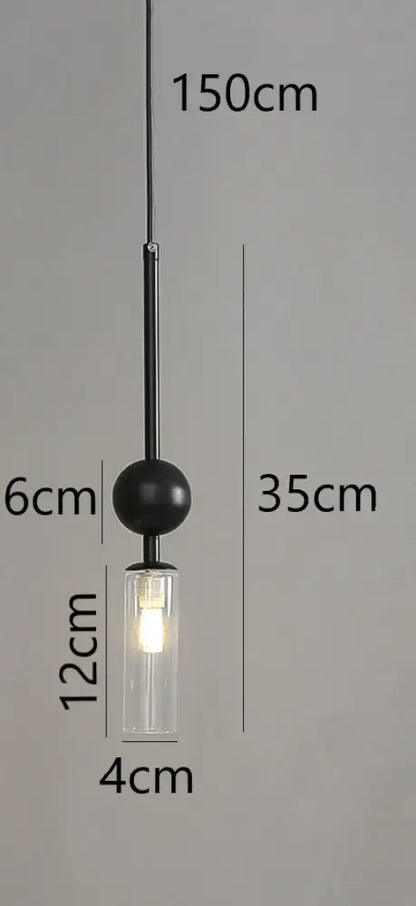 Modern brass and black glass pendant light with black spherical shade and clear glass cylinder housing led bulb suspended by chain