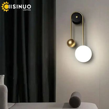 Modern brass and black led wall sconce with sleek gold frame and two spherical shades for living room decorbites led wall light