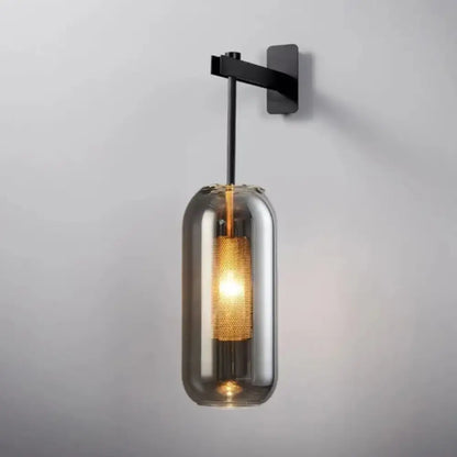 Modern brass and black wall sconce light with smoked glass and illuminated golden mesh for bedroom use