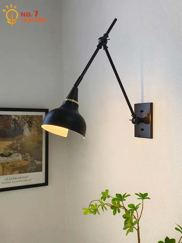 Black metal wall lamp with adjustable swing arm and matte brass black finish for modern bedroom decorbites brass black