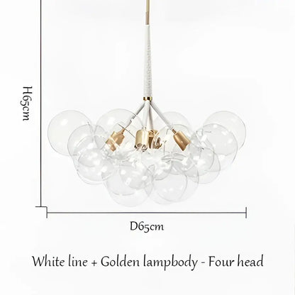 A modern brass bubble chandelier with four clear glass globes suspended from a white line by decorbites bubble chandelier