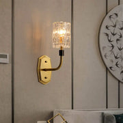 Modern brass living room wall sconce with gold-toned finish and clear faceted crystal glass shade inch fixture