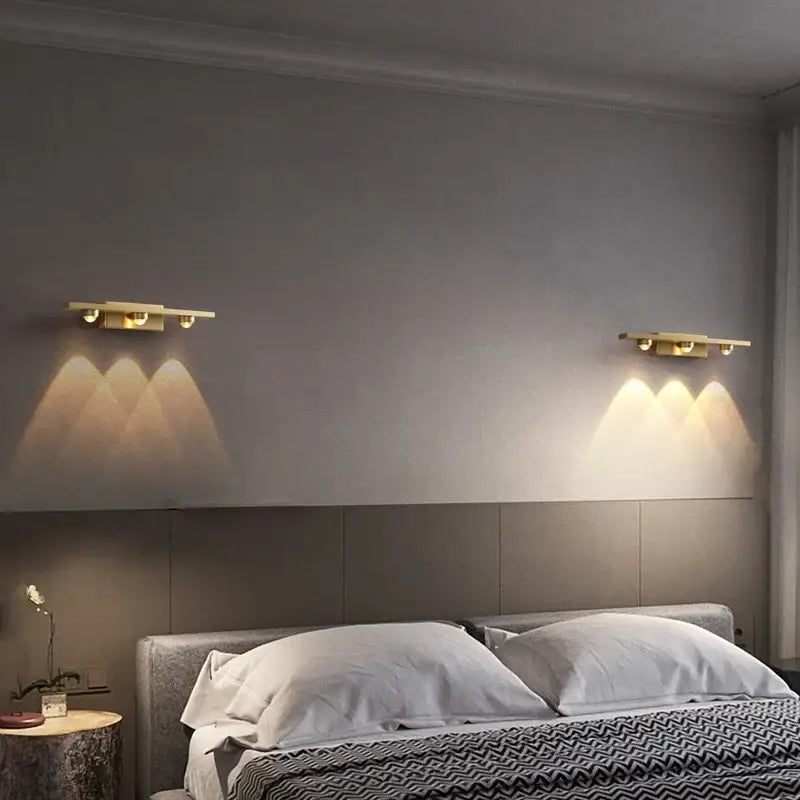 Modern brass copper led wall lamp with gold-toned adjustable spotlights mounted symmetrically as bedroom reading light decorbites copper led wall
