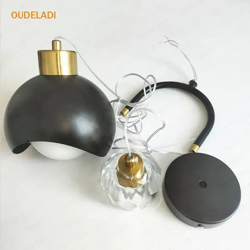 Modern brass crystal ball pendant light with black matte and gold-toned brass top for elegant bedroom decorbites pendant lights