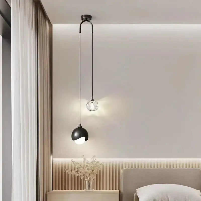 Modern brass crystal ball pendant light featuring a black spherical fixture with a clear faceted glass globe for decorbites pendant lights
