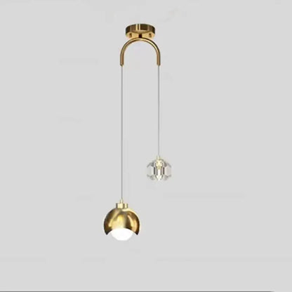 Modern brass crystal ball pendant light with gold-toned metal arm, polished dome shade, and decorbites crystal ball fixture