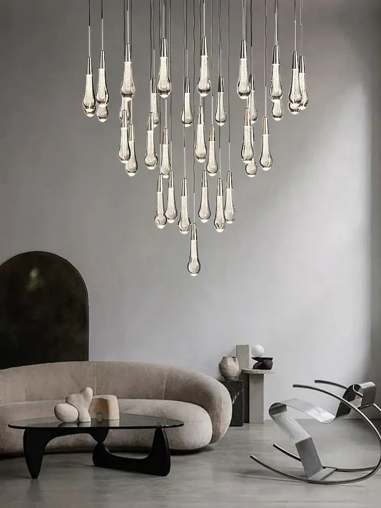Modern pendant light with brass crystal ceiling and teardrop-shaped glass elements for dining room decorbites brass crystal