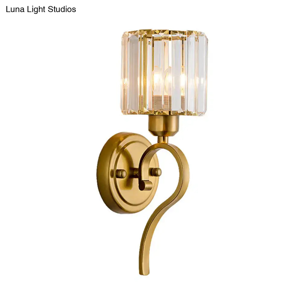 Modern brass crystal cylinder wall sconce with gold finish curved metal arm and crystal block cylinder shade for bedroom lighting