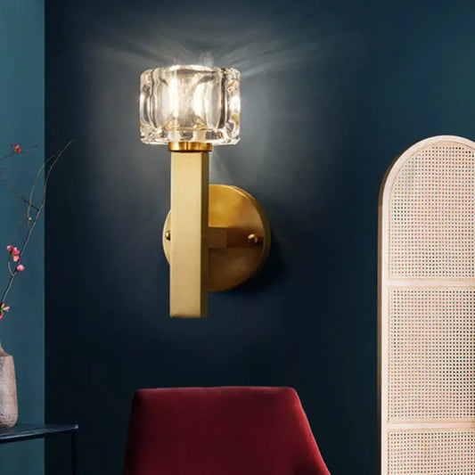 Modern brass crystal wall sconce with faceted clear crystal shade and polished brass finish for contemporary cube flush lighting