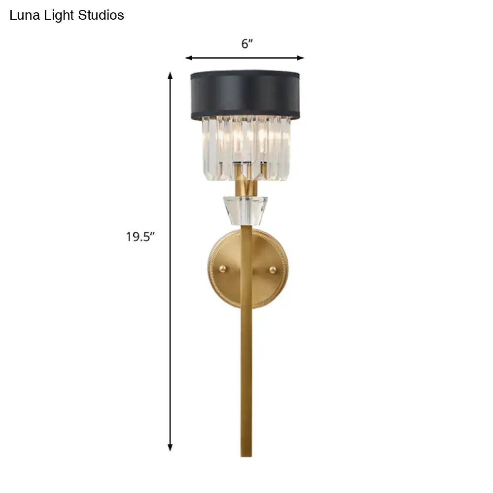 Modern brass cylinder wall sconce with gold metal base and black fabric shade featuring clear crystal prisms for bedroom light
