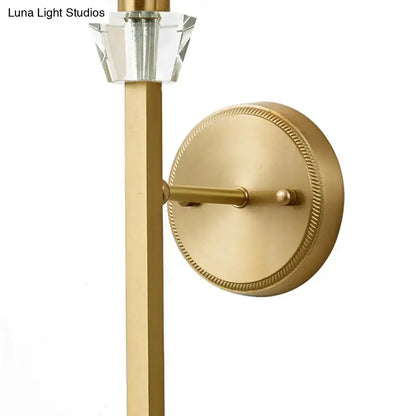 Modern brass cylinder wall sconce with fabric shade and clear crystal accent for bedroom lighting