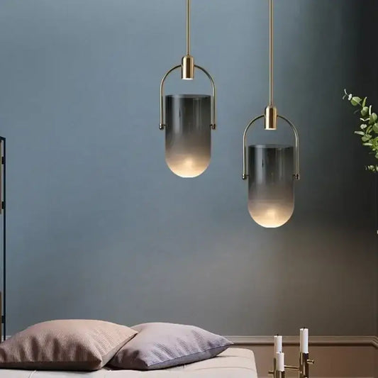 Two modern pendant lights with brass metal frames and gradient gray glass shades from decorbites bucket chandelier