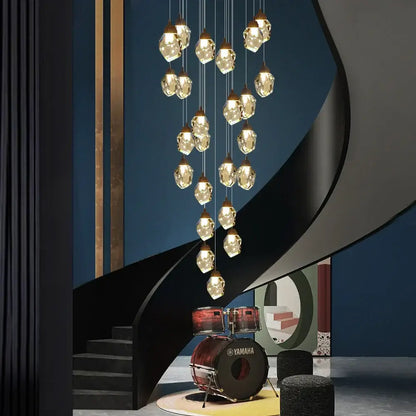 A modern brass decorbites crystal led chandelier with multiple clear faceted crystal pendants for living room lighting