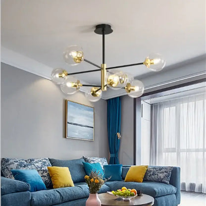 Modern brass decorbites glass ball led chandelier with black rod and gold accents featuring clear glass globe bulbs