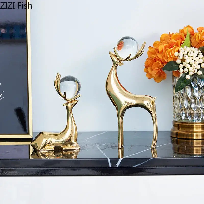 Modern brass deer statue desk ornament with polished metallic finish and crystal orbs balanced on antlers for living room decor