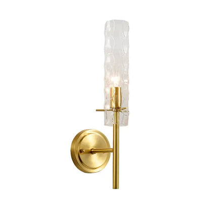 Modern brass dimpled blown glass wall light with textured translucent gold-toned blown glass cylinder shade for bedroom
