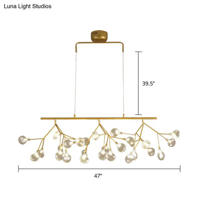 Gold-toned decorbites™ 27-bulb island light with brass finish and clear glass globe bulbs in minimalist branch design 220v-240v