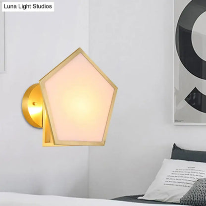 Modern brass finish pentagon wall lamp with gold-finished metal and warm-toned pink translucent glass shade