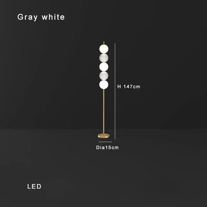 Modern brass floor lamp with six gray and white glass spheres on a slender gold-toned stand for living room decorbites brass floor lamp
