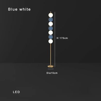 Modern brass floor lamp with slender gold-toned stand and six alternating blue and white spheres for living room decorbites brass floor lamp
