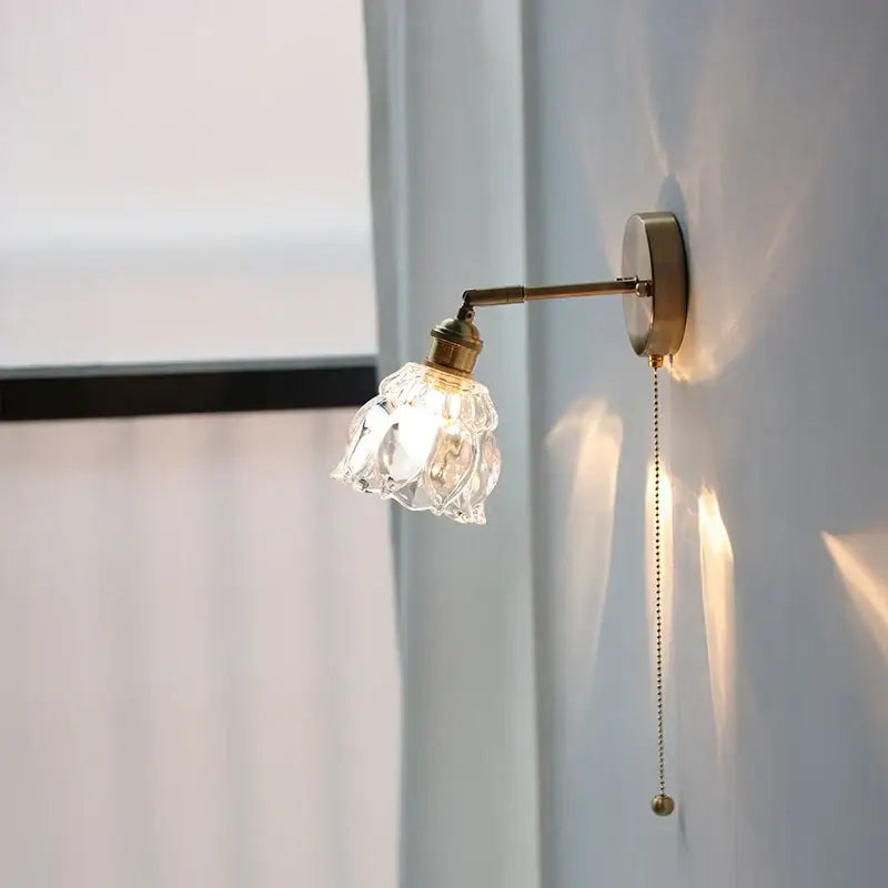Modern brass floral wall sconce with faceted clear glass shade and pull chain by decorbites clear glass decor
