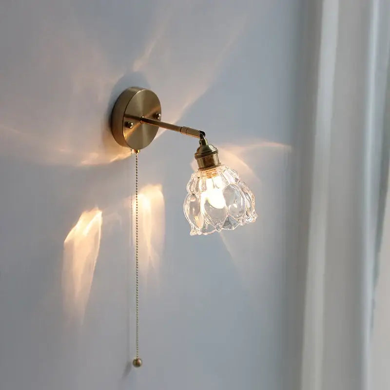 Modern brass floral wall sconce with clear glass faceted shade and adjustable arm by decorbites clear glass